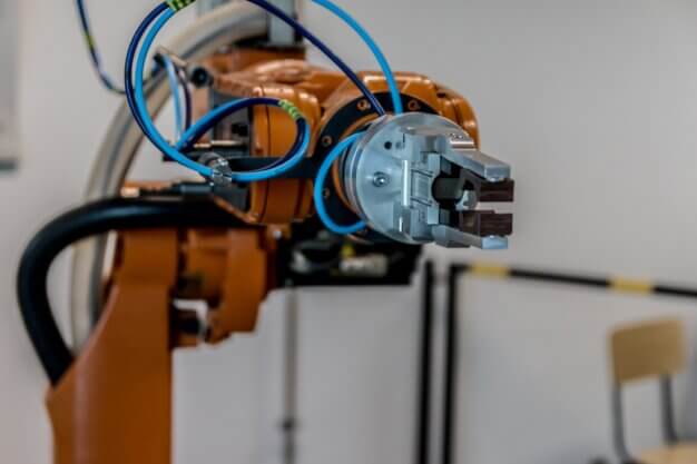 Industrial robotic arm in a manufacturing setting